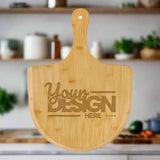Wooden pizza peel with 'Your Design Here' text on a white background