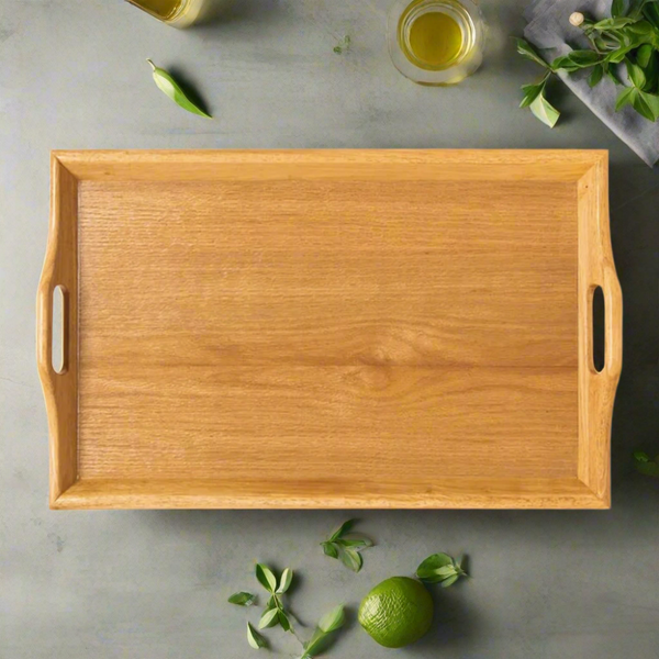 Wooden tray on a gray surface with a lime and mint leaves.