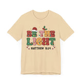 Be the Light Christmas T-Shirt - Colorful Holiday Design with Santa Hat and Lights - Festive Cheerful Apparel
