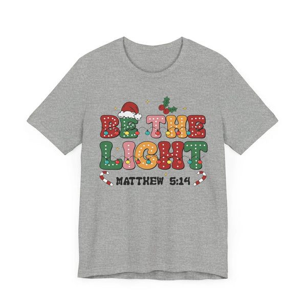 Be the Light Christmas T-Shirt - Colorful Holiday Design with Santa Hat and Lights - Festive Cheerful Apparel